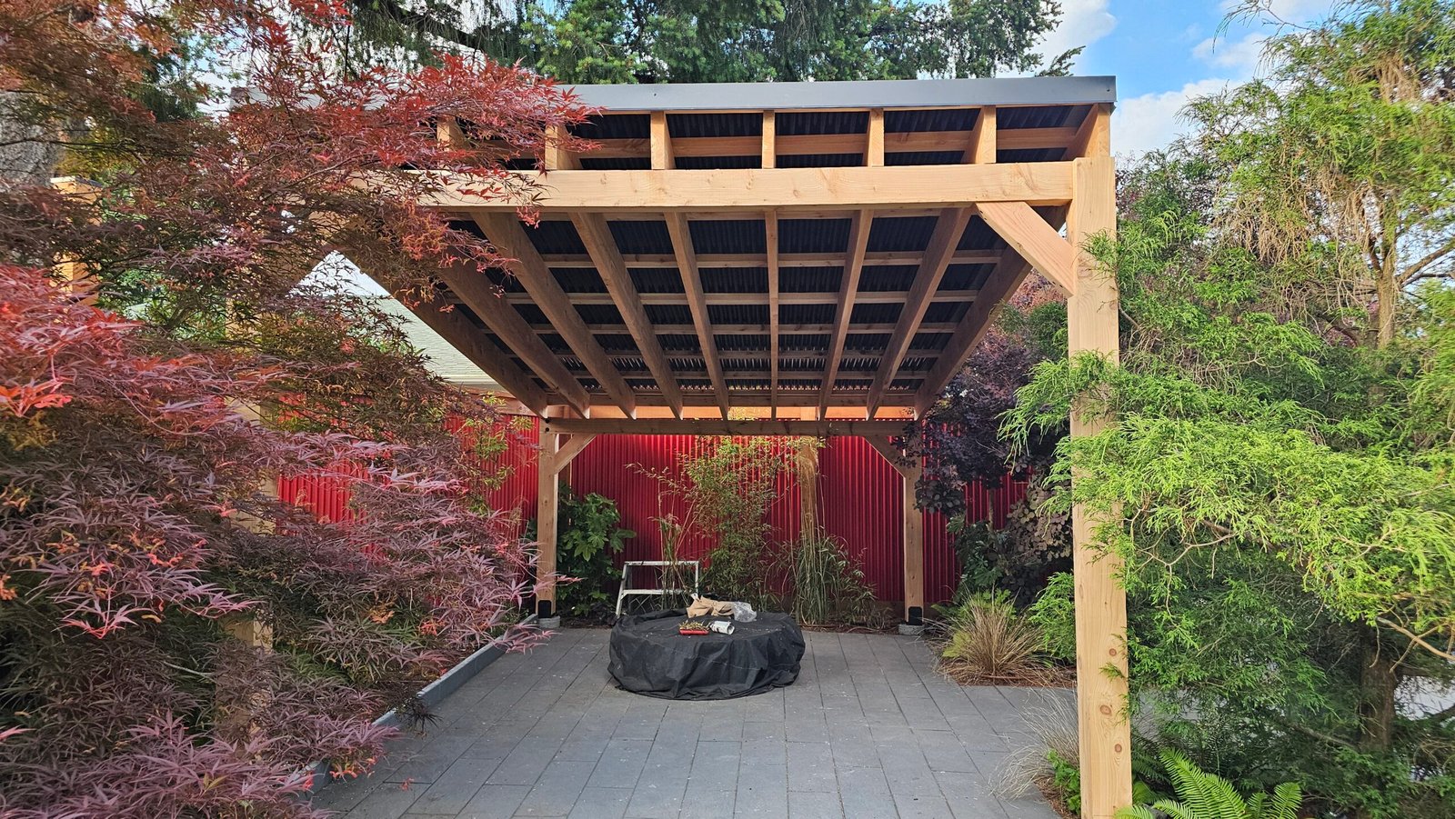 Timber roof structure over a furnished outdoor patio