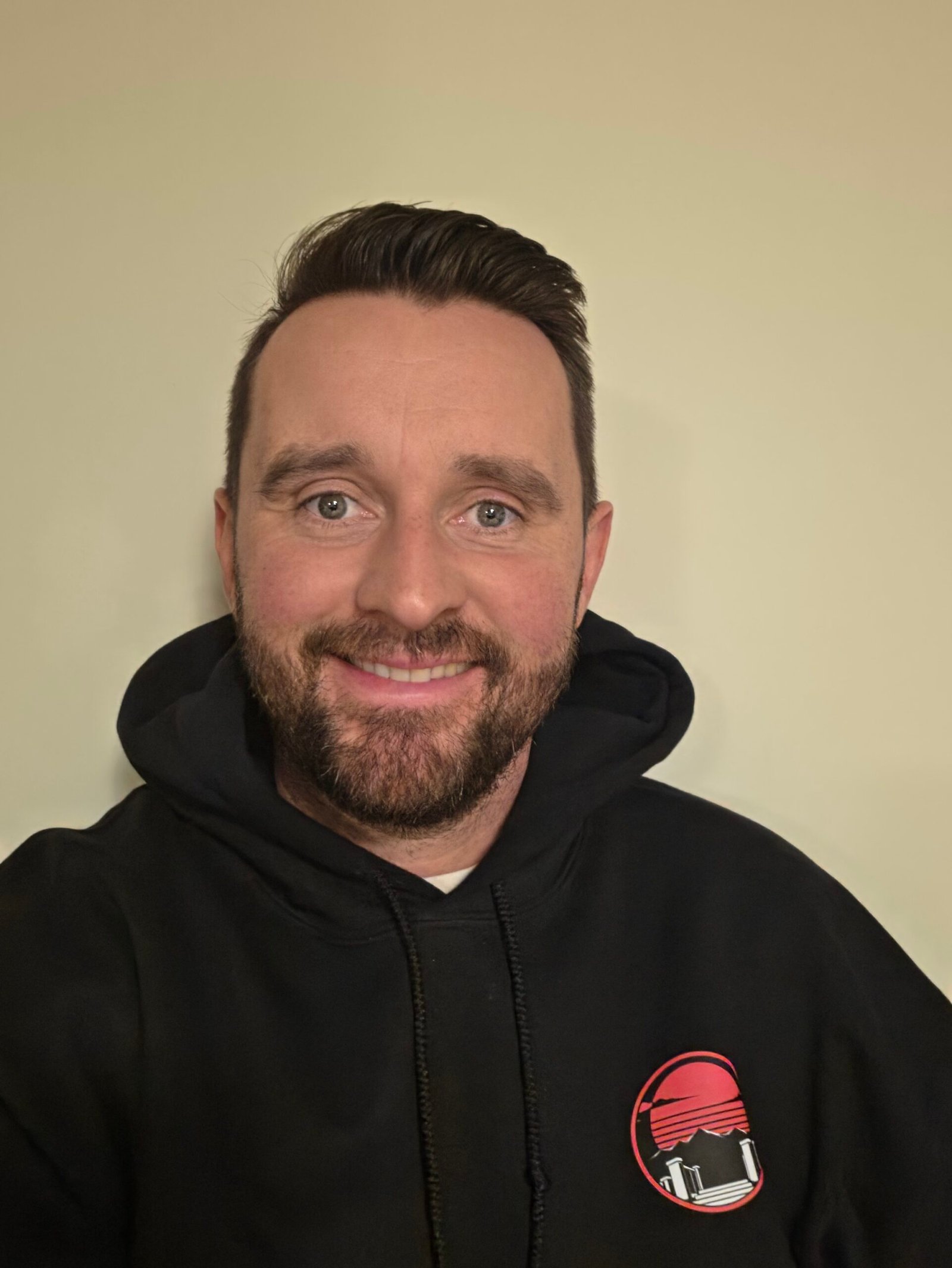 Chris Aldridge, owner of Dynamic Fencing and Decks, wearing a company hoodie