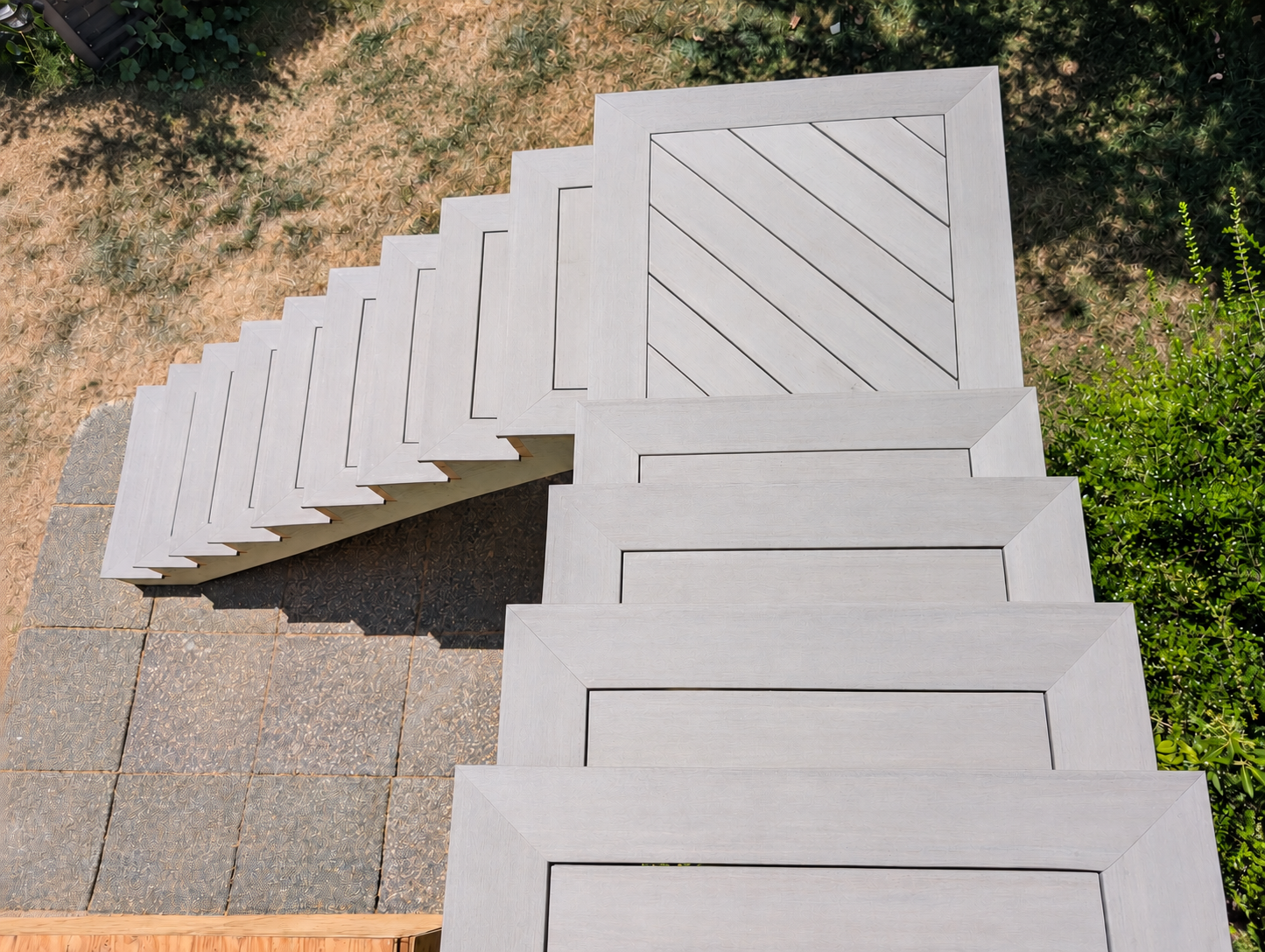 Finished gray stairs with matching plugs and a 45-degree landing